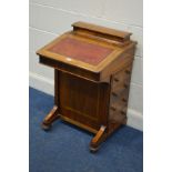 A LATE VICTORIAN WALNUT AND BURR WALNUT BANDED DAVENPORT, with a domed and hinged oblong