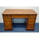 AN EDWARDIAN MAHOGANY PEDESTAL DESK, with a brown gilt tooled leather inlay top and nine drawers,