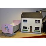 A SECOND HALF 20TH CENTURY WOODEN DOLLS CRADLE AND A WOODEN DOLLS HOUSE, with lift off roof and
