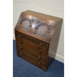 AN OAK BUREAU with four drawers, width 77cm x depth 44cm x height 99cm