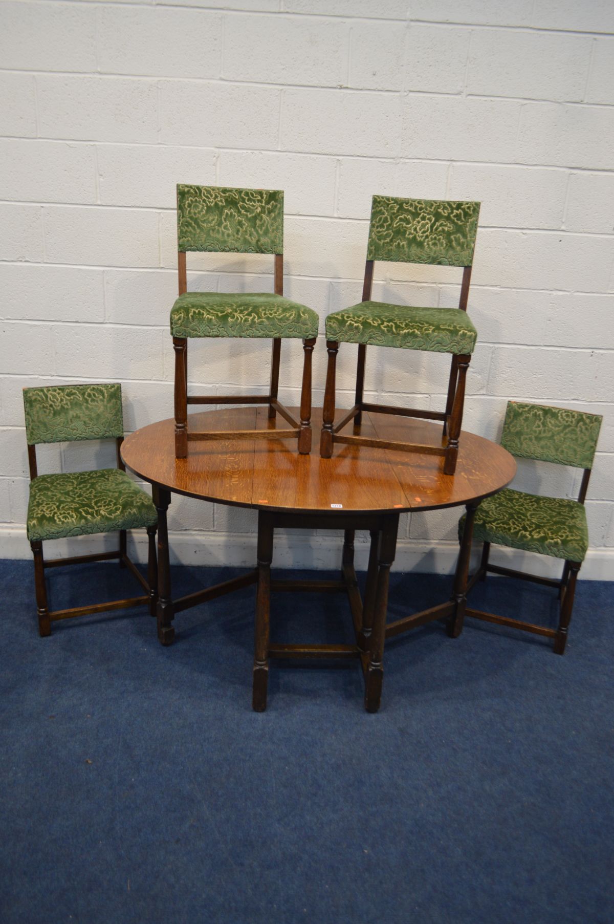 A 1940'S OAK GATE LEG TABLE and four chairs (5)