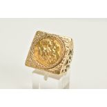 A 9CT GOLD HALF SOVEREIGN RING, the half sovereign dated 1910, set within a textured square