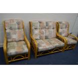 A WICKER THREE PIECE CONSERVATORY SUITE, with removable cushions, comprising a two seater settee and