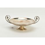 A DOUBLE HANDLED SILVER DISH, the dish with rimmed design with each handle of a foliate scroll,