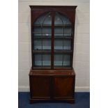 A GEORGIAN ASTRAGAL GLAZED DOUBLE DOOR BOOKCASE, with three adjustable shelves above double panelled
