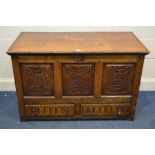 A GEORGIAN OAK COFFER, the front having triple carved fielded panels, over two drawers with