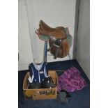 A WROUGHT IRON SADDLE STAND, a leather saddle, two helmets, a Robin Body Protector etc