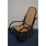 A BENTWOOD ROCKING CHAIR with a cane back and seat
