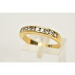 AN 18CT GOLD HALF HOOP DIAMOND RING, designed with a row of nine channel set round brilliant cut