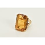 A 9CT GOLD CITRINE RING, designed with a large claw set, rectangular cut citrine, floral engraved