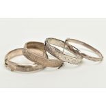 FOUR SILVER BANGLES, the first hinged bangle of a foliate engraved design, rope twist edge with