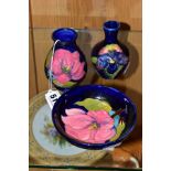 THREE PIECES MOORCROFT POTTERY, two 'Magnolia' pattern on blue ground items, a bud vase, height