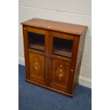 AN EDWARDIAN WALNUT TWO DOOR BOOKCASE, with bevelled glass doors above marquetry panels, width