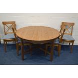 A MODERN PINE CIRCULAR EXTENDING DINING TABLE, diameter 127cm x height 75cm and four chairs with