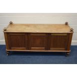 A VICTORIAN WALNUT CABINET, with triple panelled doors, on turned legs and ceramic casters, width