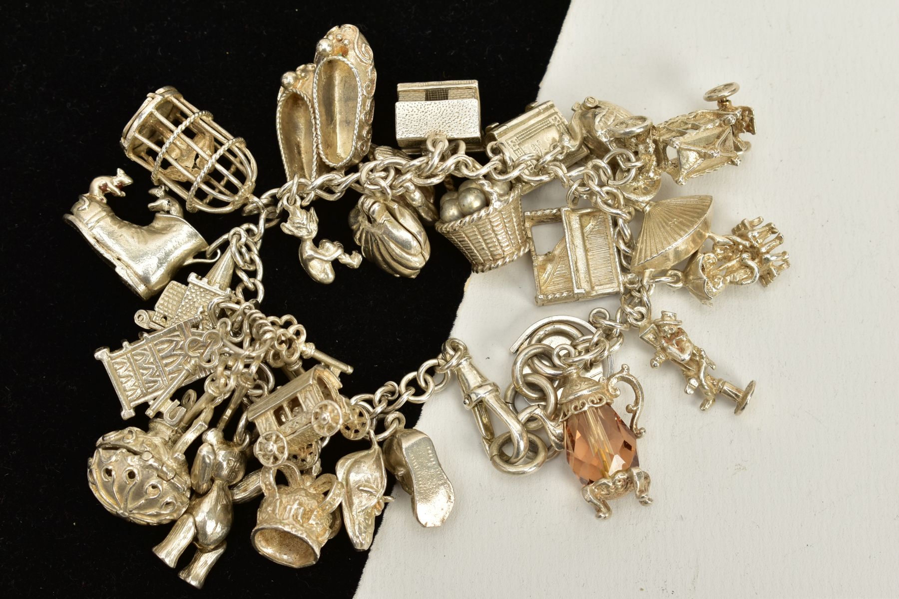 A CHARM BRACELET, suspending twenty five charms in forms such as a bird in a cage, ballerina - Bild 2 aus 2