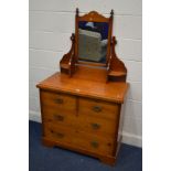 A STAINED PINE DRESSING CHEST with a swing mirror, two short over two long drawers, width 92cm x