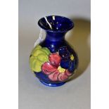A MOORCROFT POTTERY BULBOUS VASE, purple Clematis on a dark blue ground, impressed marks and blue '