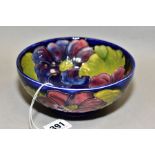A MOORCROFT POTTERY CIRCULAR FOOTED BOWL, blue and purple clematis on a blue back ground,