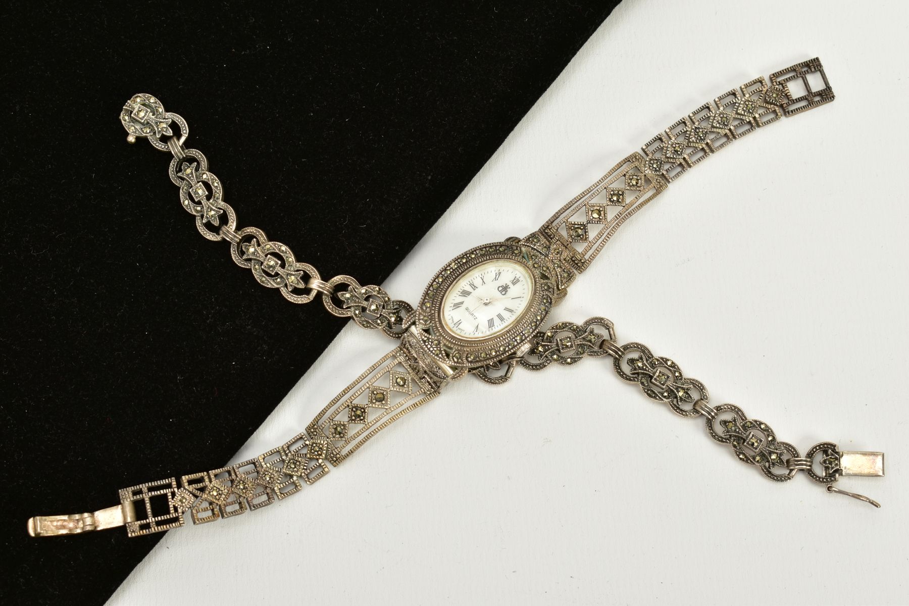 A LADIES SILVER MARCASITE WATCH AND BRACELET, the watch of oval design, white dial, Roman
