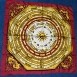 A HERMES SILK SCARF DECORATED WITH SIGNS OF THE ZODIAC, no signature to border, dark red ground with