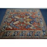 AN EAGLE KAZAK GROUND RUG, blue eagle on a red field, 267cm x 238cm