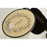 A WHITE METAL LINK BRACELET, the oval link bracelet, suspending two circular charms, the first of