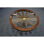 AN OAK NOVELTY SHIPS WHEEL COFFEE TABLE with a glass insert, diameter 75cm x height 42cm