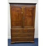 A GEORGIAN MAHOGANY LINEN PRESS, carved cornice, double panelled doors enclosing four linen slides