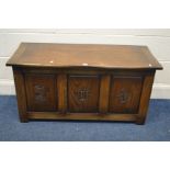 A REPRODUCTION OAK BLANKET CHEST, with triple carved fielded panels, width 108cm x depth 46cm x