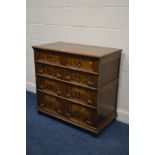 A REPRODUCTION OAK CHEST OF FOUR LONG GRADUATING GEOMETRIC FRONTED DRAWERS, with drop handles, width