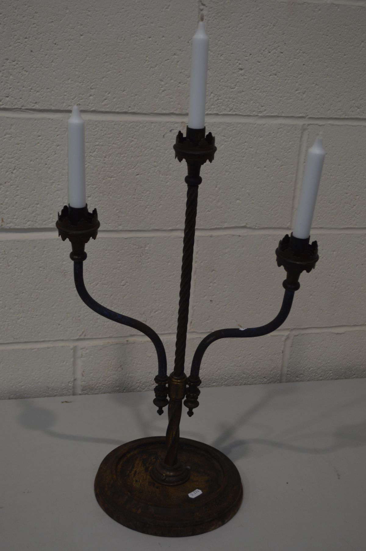 A WROUGHT IRON TRIPLE BRANCH CANDLE STAND