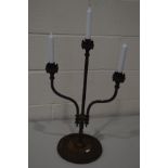 A WROUGHT IRON TRIPLE BRANCH CANDLE STAND