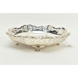 A SILVER DISH, designed with a plain polished bowl to an openwork wavy edge, raised up on four