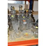 A GROUP OF GLASSWARE, including five decanters, three vases, a pedestal bowl, cylindrical jug,