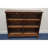 AN EDWARDIAN MAHOGANY THREE SECTION BOOKCASE, the fielded side panel's, on shaped bracket feet,