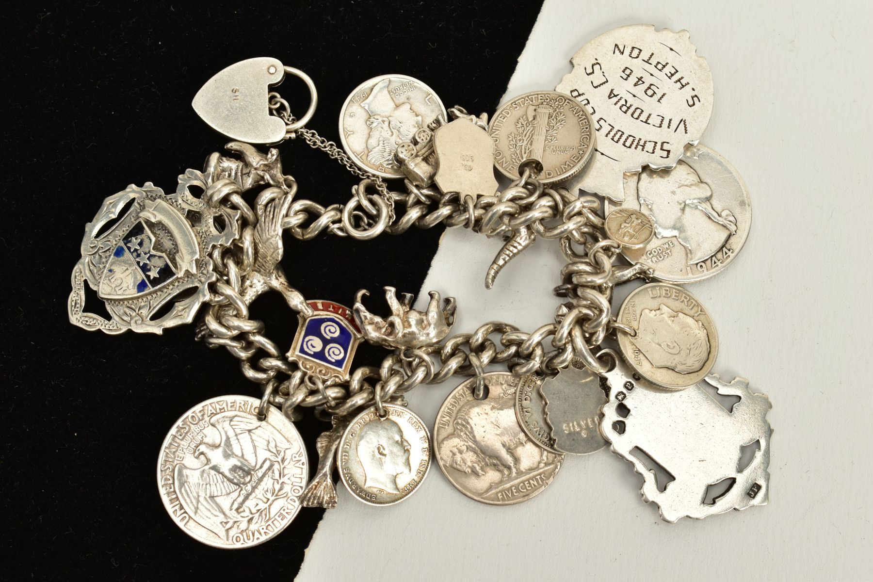 A SILVER CHARM BRACELET, suspending twenty-three charms, such as coins, fobs, a dog, crocodile, - Image 2 of 2