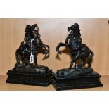A PAIR OF LATE 19TH CENTURY BRONZED MARLY HORSES, after Coustou, mounted on black slate plinths