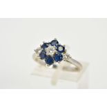 AN 18CT WHITE GOLD DIAMOND AND SAPPHIRE CLUSTER RING, the raised cluster designed with a central