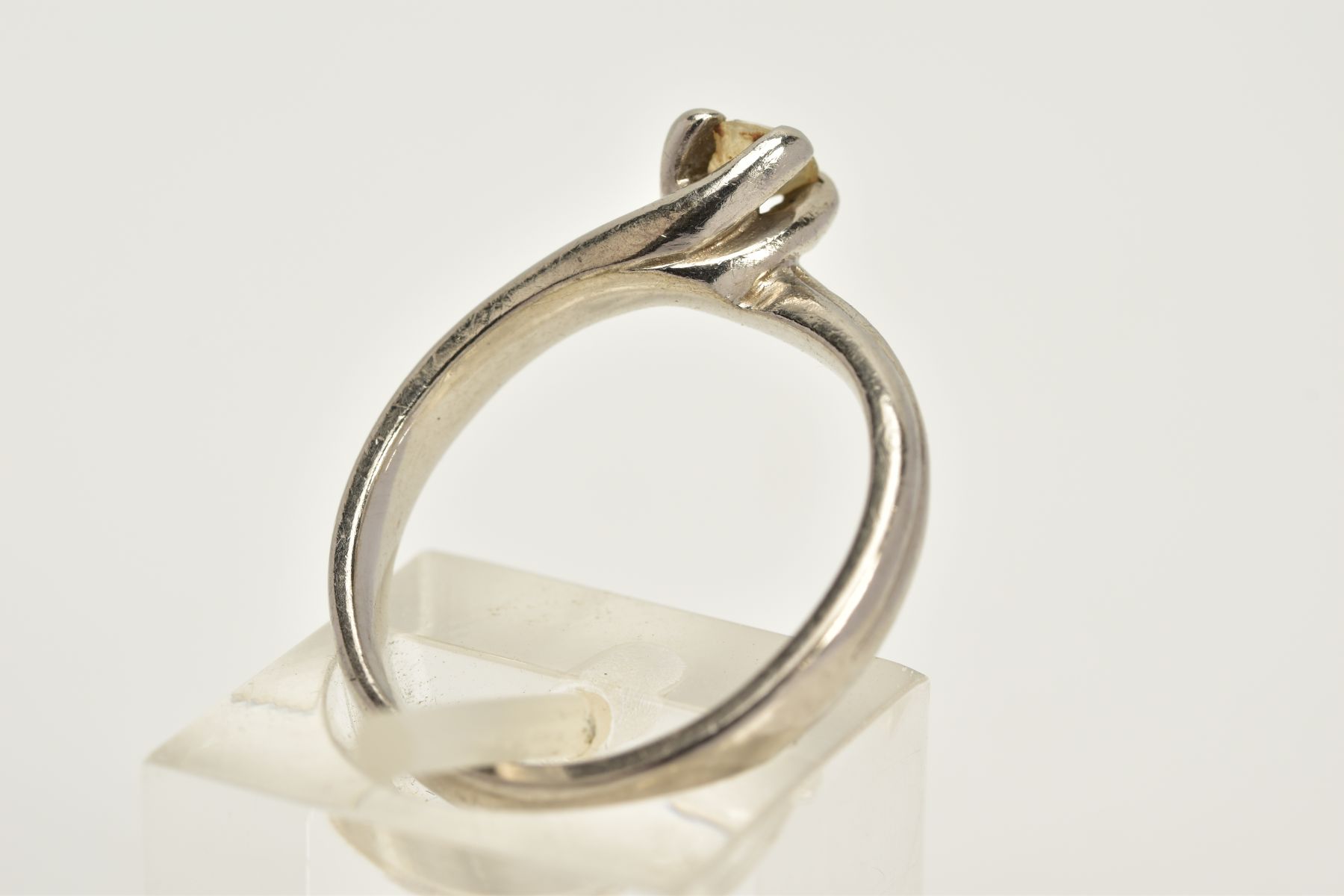 A PLATINUM SINGLE STONE DIAMOND RING, of crossover design, with a claw set round brilliant cut - Image 3 of 5