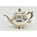 A GEORGE V SILVER TEAPOT, designed with a flat circular rimmed foot, plain polished rimmed design to