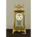A LATE 19TH CENTURY BRASS AND GILT METAL MANTEL CLOCK, with twin handled urn finial above a case