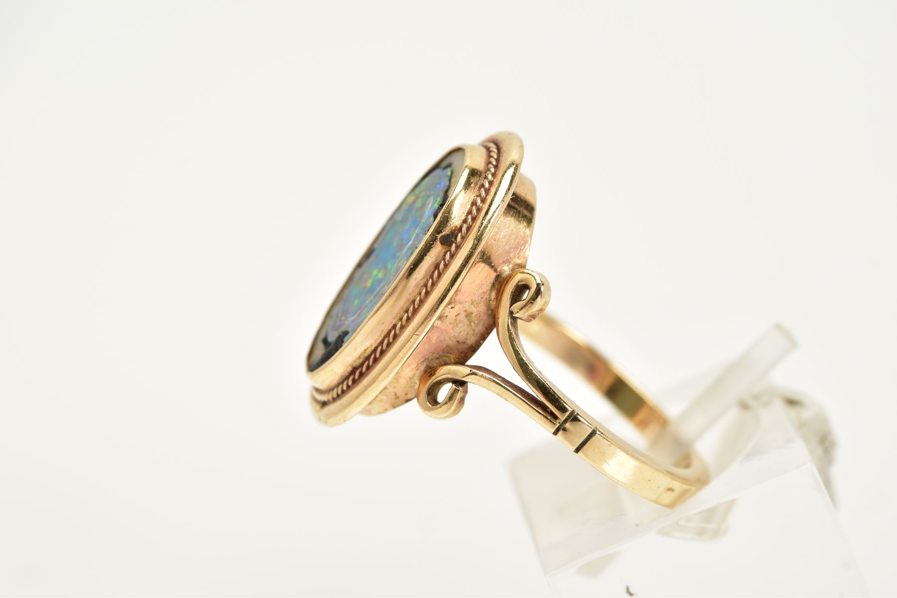 A YELLOW METAL RING, of oval design, set with a broken opal triplet, within a collet mount and - Image 2 of 4