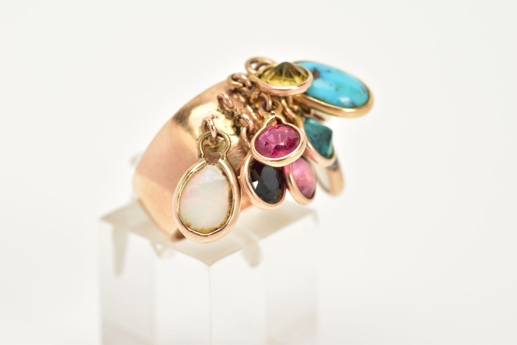 A YELLOW METAL MULTI-GEMSTONE RING, the plain polished wide shank, suspends nine drops containing - Image 4 of 4