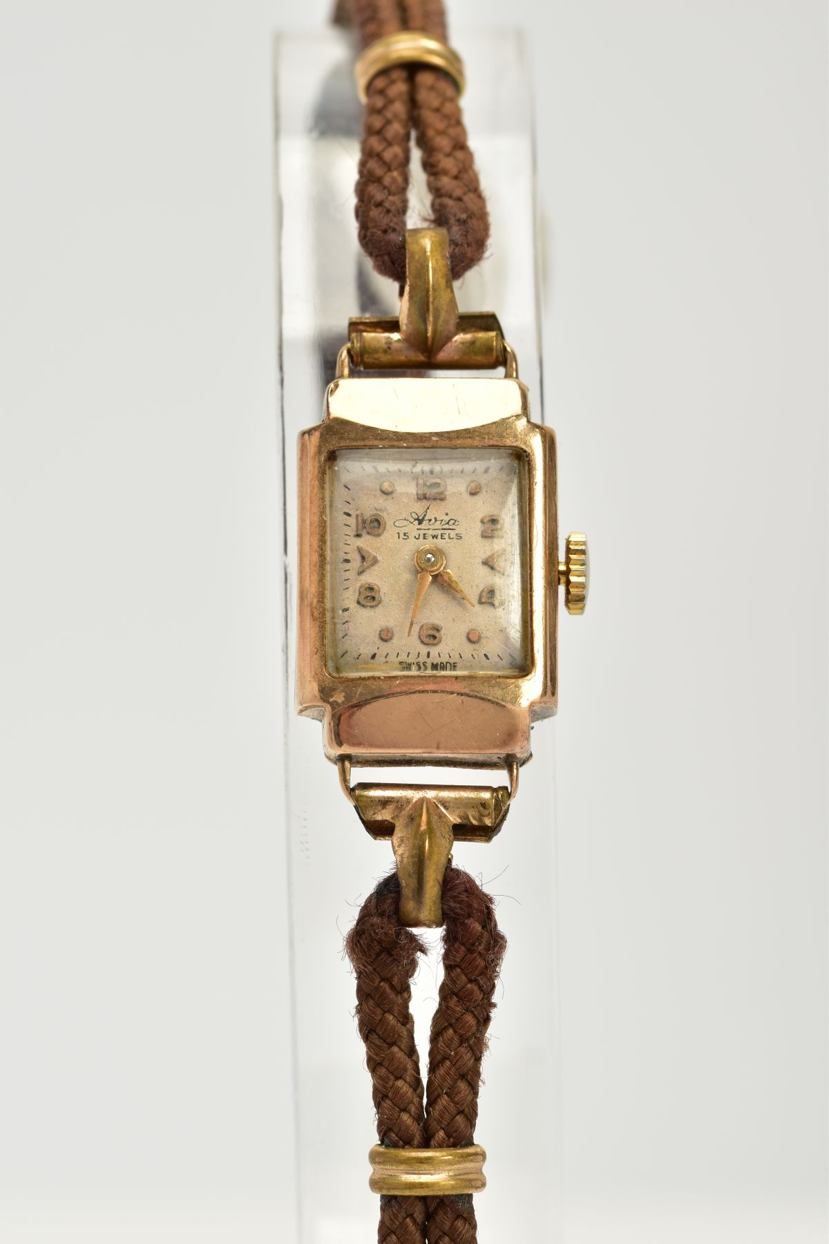 A 9CT GOLD LADYS HAND WOULD 'AVIA' COCKTAIL WRISTWATCH, the rectangular case with a square cream