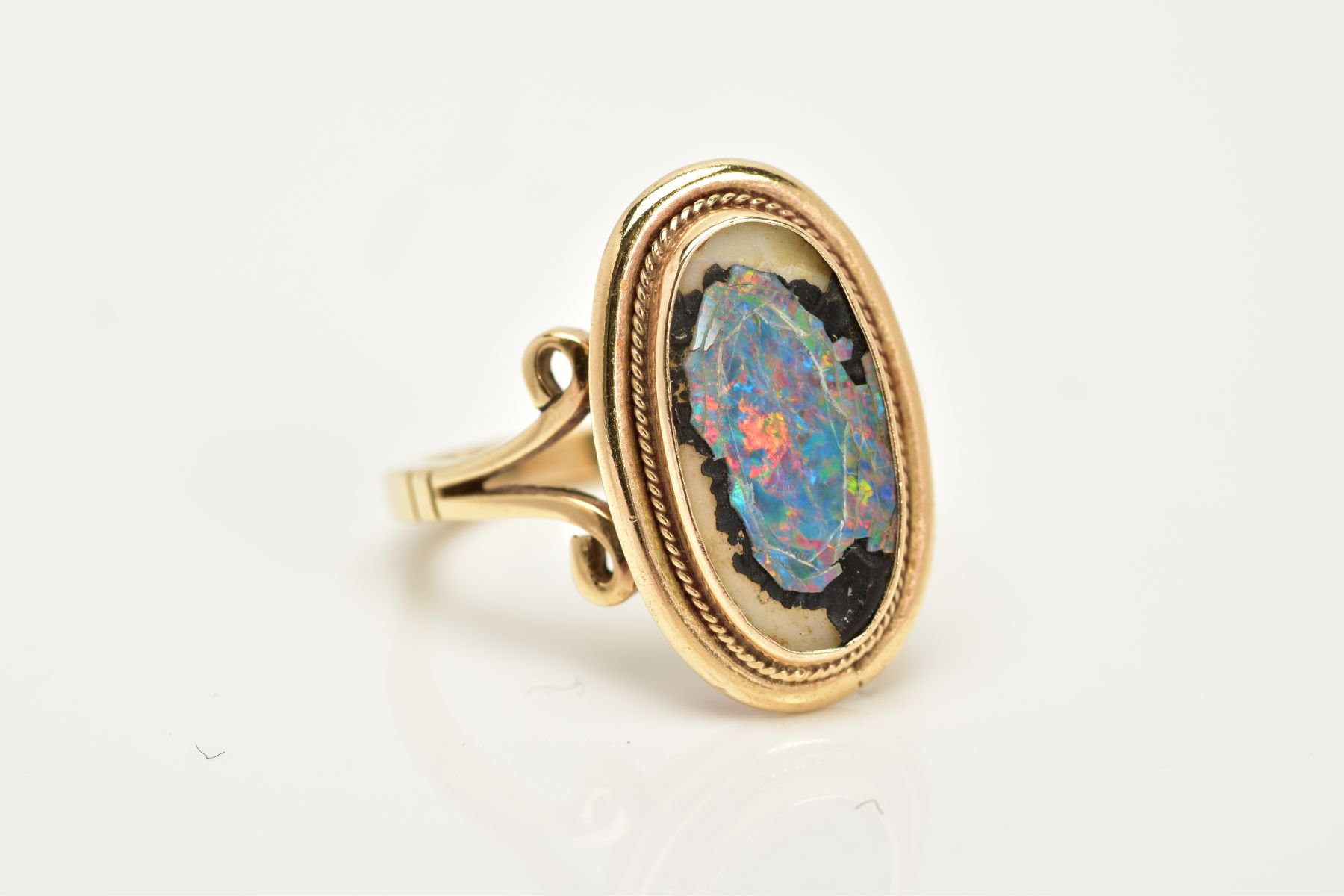 A YELLOW METAL RING, of oval design, set with a broken opal triplet, within a collet mount and - Image 4 of 4