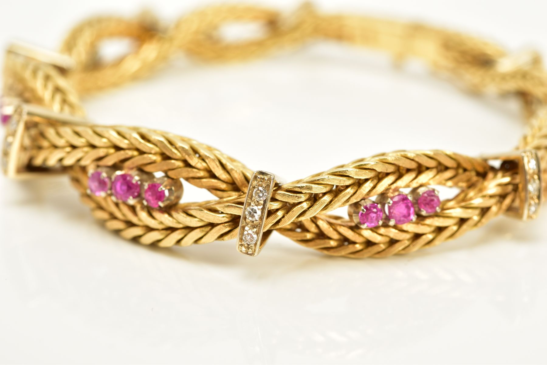 A MODERN YELLOW METAL DIAMOND AND RUBY BRACELET, designed as a twisted box chain bracelet, seven - Image 2 of 6