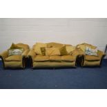 A LATE 19TH/EARLY 20TH CENTURY MAHOGANY FRAMED THREE PIECE LOUNGE SUITE, with mustard coloured