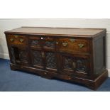 A GEORGIAN OAK DRESSER BASE, the plank cross banded top above central double cupboard doors,