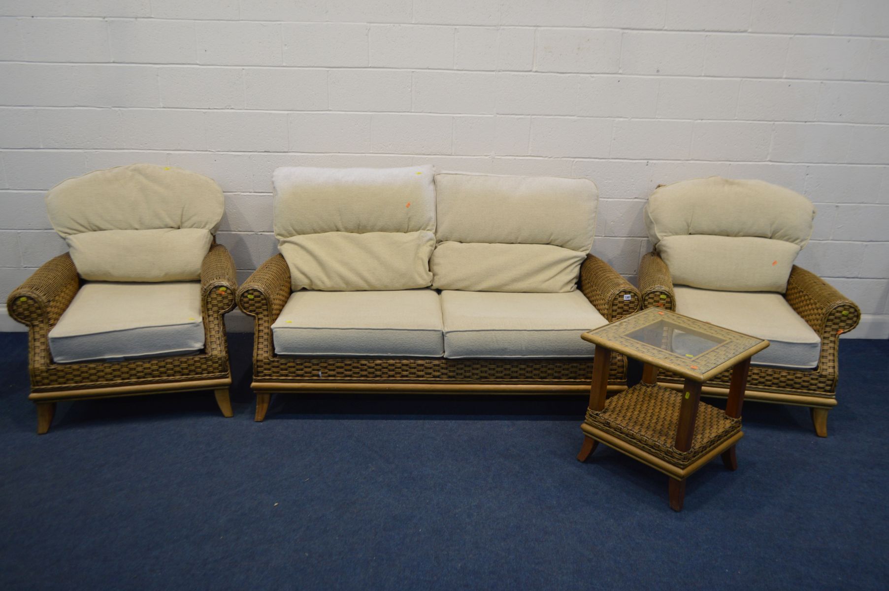 A FOUR PIECE CONSERVATORY SUITE, cream cushions, comprising a two seat settee, two armchairs and